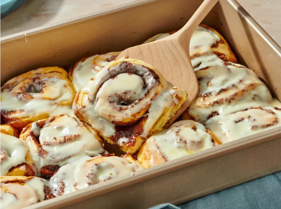 Delicious spicy cinnamon rolls in a baking tray
